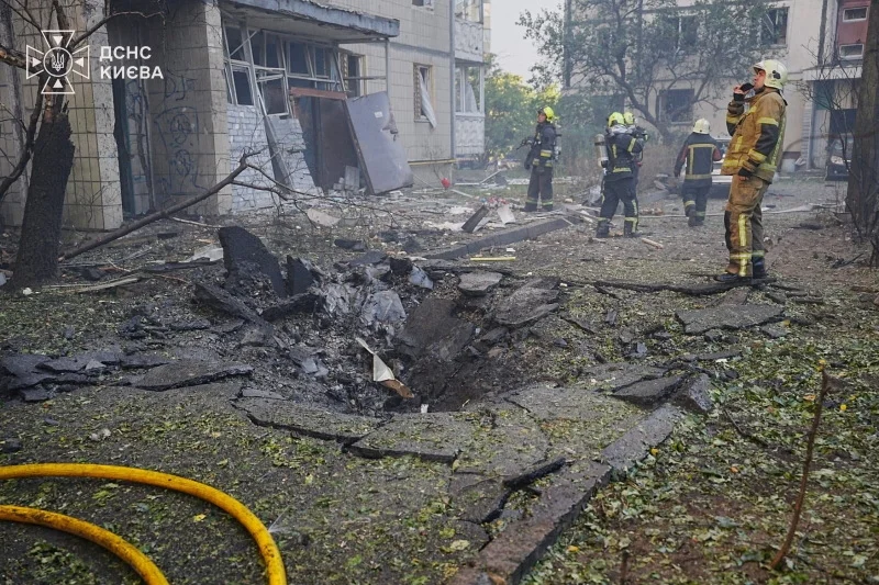 Russian air strikes wound two and set Kyiv apartment building on fire, officials say